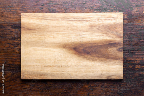 Cutting board on wood kitchen table. Food recipe concept at wood background texture with copy space.