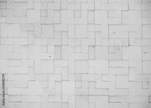 embossed stone tile wall with geometric patterns as colorless black and white background 