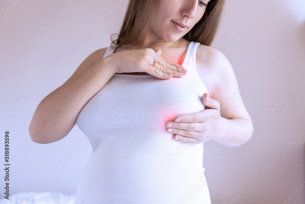 Breast pain self exam. Young pregnancy woman examining breast for signs