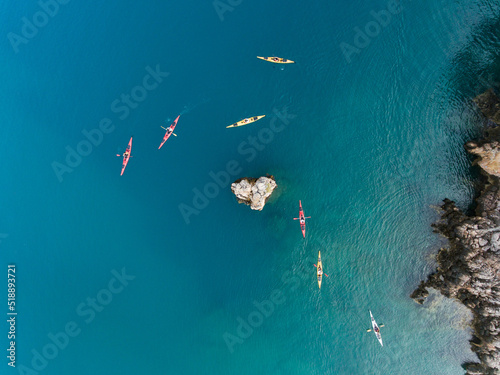 Canvas Print Aerial view of a group of sea kayakers in crystal clear water of Mediterranean S