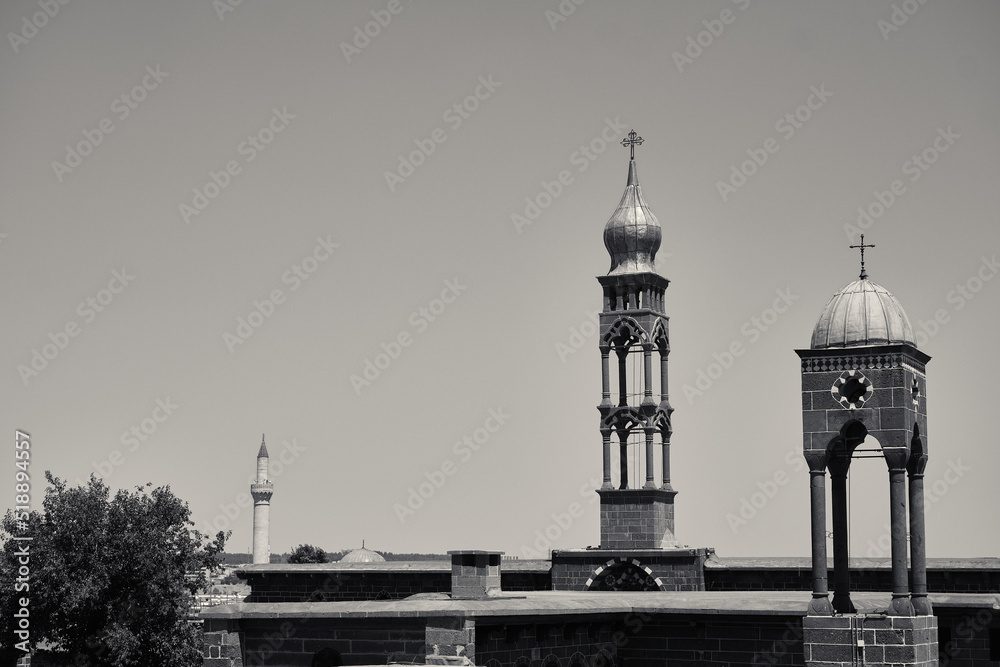 Fototapeta premium Top of Mar Petyun Keldani Church, Armenian Church and muslim mosque in one photo in Diyarbakir.