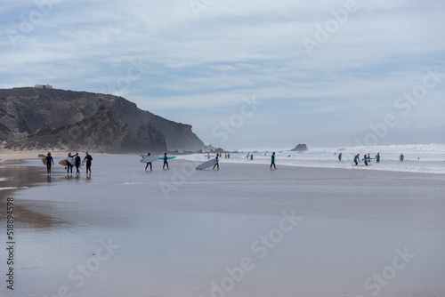 People on the beach and surfers at Atlantic Ocean, Portugal 