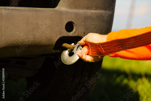 Male hand attaching towline to car photo