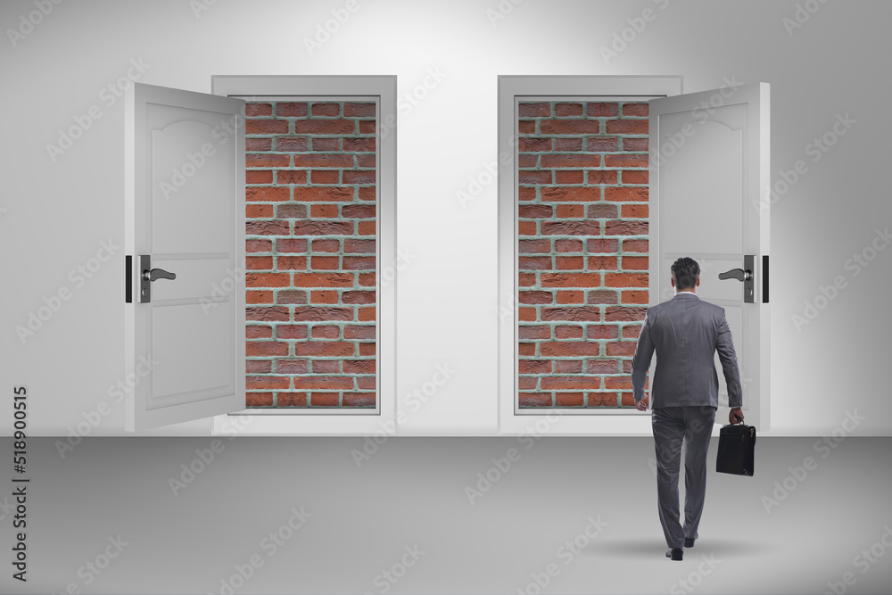 Fototapeta premium Businessman facing no exit with brick door