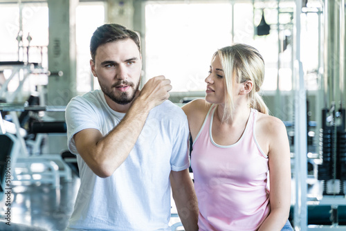 Smart sport man and woman working out in fitness gym