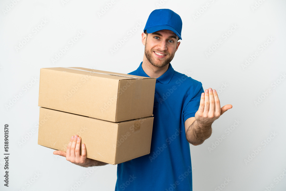 Delivery man over isolated white background inviting to come with hand. Happy that you came Delivery man over isolated white background inviting to come with hand. Happy that you came