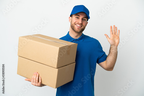 Delivery man over isolated white background saluting with hand with happy expression © luismolinero