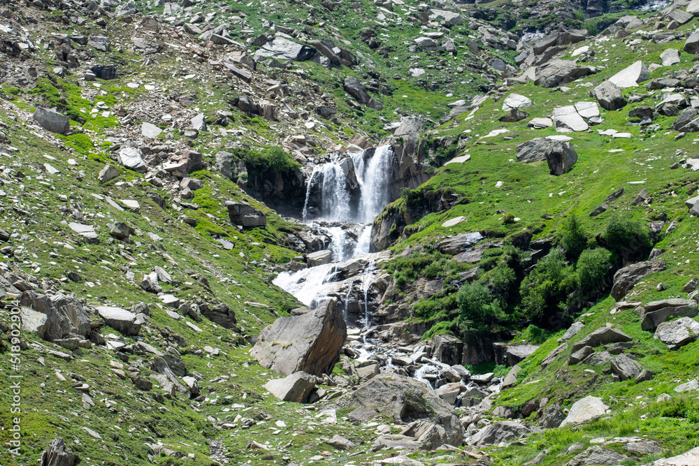beautiful and spectacular waterfall can be seen enroute rohtang pass near manali, Himachal pradesh, India. A perfect summer morning landscape of lush green and rocky mountains and powerful waterfall. beautiful and spectacular waterfall can be seen enroute rohtang pass near manali, Himachal pradesh, India. A perfect summer morning landscape of lush green and rocky mountains and powerful waterfall.