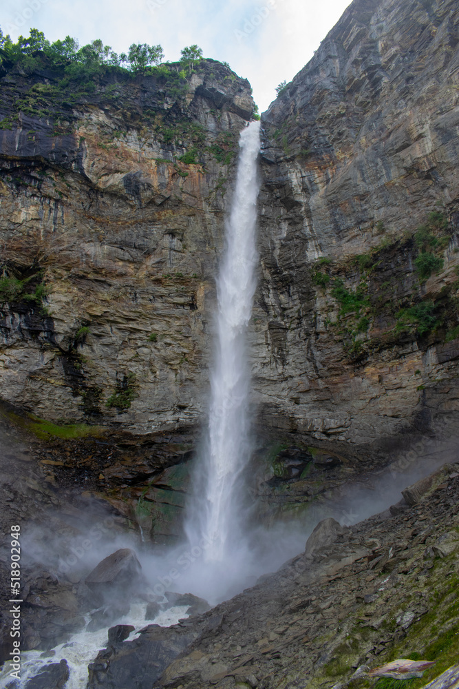 Mighty Sissu waterfall falling with all the force in Lahaul valley, Himachal Pradesh. Waterfall falling from rocky mountain. Waterfall surrounded by Green mountains and clear skies on a pleasant day. Mighty Sissu waterfall falling with all the force in Lahaul valley, Himachal Pradesh. Waterfall falling from rocky mountain. Waterfall surrounded by Green mountains and clear skies on a pleasant day.