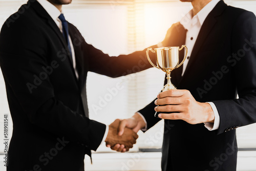 success business and achievement team concept, successful businessman holding champion award of winner, honor gold prize and partner or manager pleased,, celebration ceremony