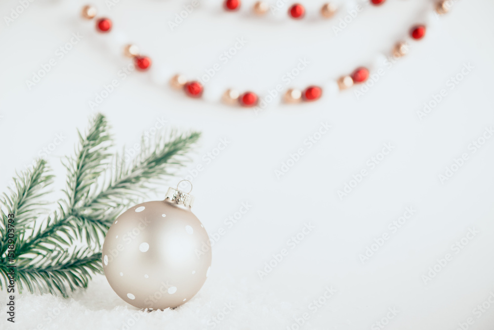 festive christmas ball on white background with snow and fir branches