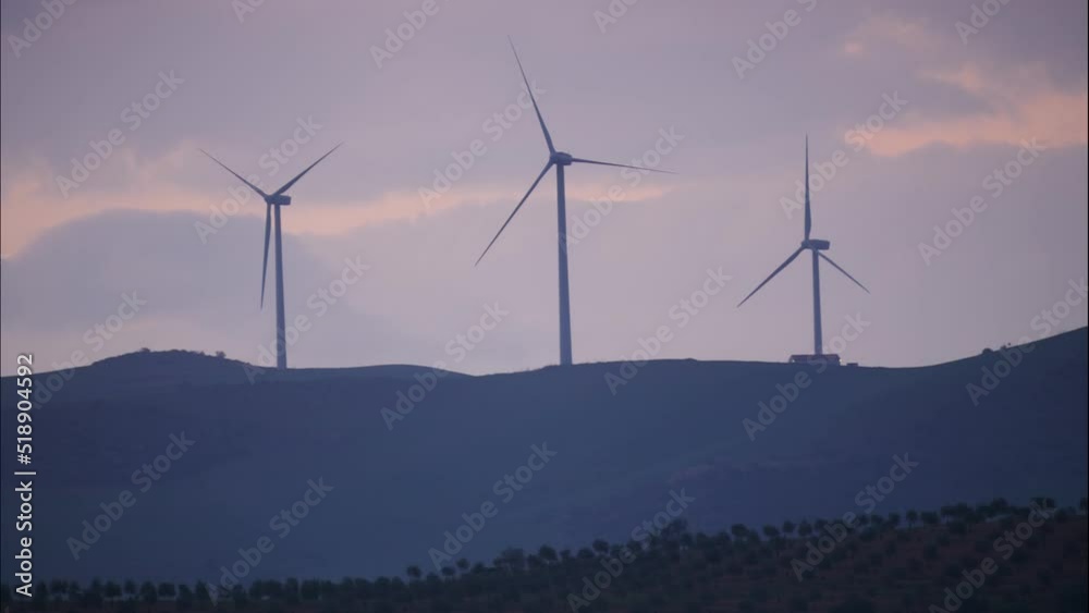 Clouds moving over wind turbines at evening. Power generator farm for renewable energy production near Ardales, province Malaga, Andalusia Spain.Time lapse Clouds moving over wind turbines at evening. Power generator farm for renewable energy production near Ardales, province Malaga, Andalusia Spain.Time lapse