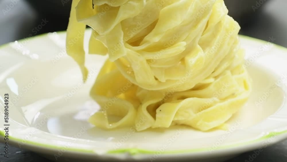 Serving pasta on a plate, slow motion.
Serving pasta on a plate, slow motion.