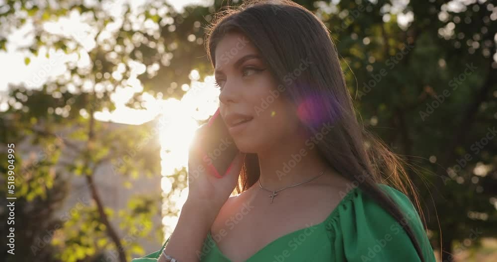 Beautiful woman say Hello into the phone at summer day, slow motion Beautiful woman say Hello into the phone at summer day, slow motion