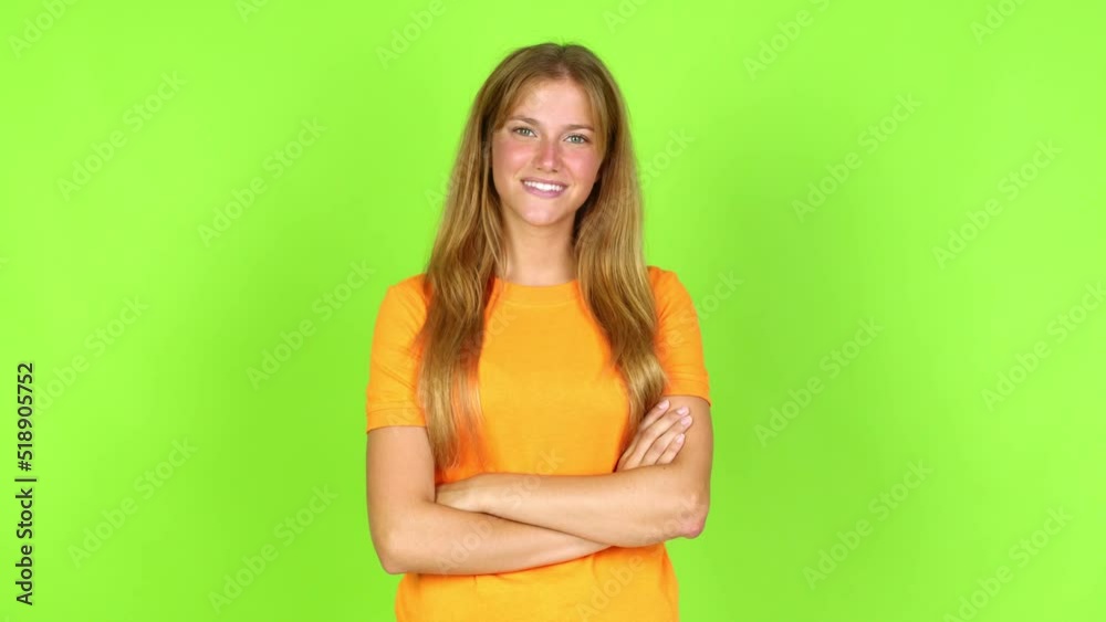 Young pretty blonde woman on green screen chroma key keeping the arms crossed in confident expression over isolated background Young pretty blonde woman on green screen chroma key keeping the arms crossed in confident expression over isolated background