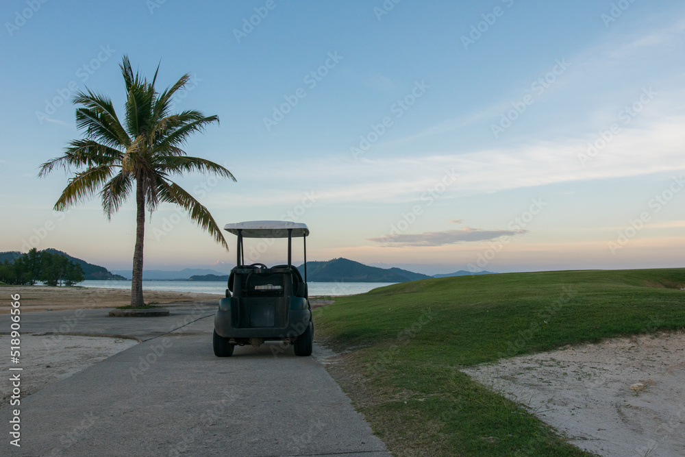 behide Golf cart on road in sunset time