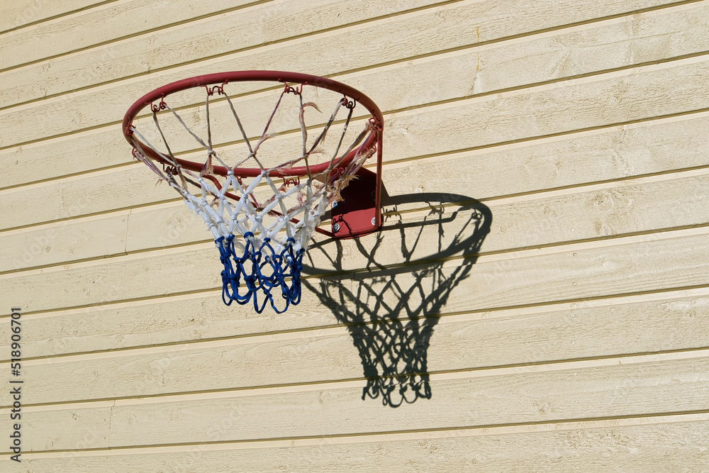 basketball hoop on wooden building wall