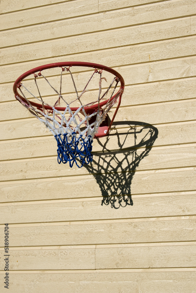 basketball hoop on wooden building wall