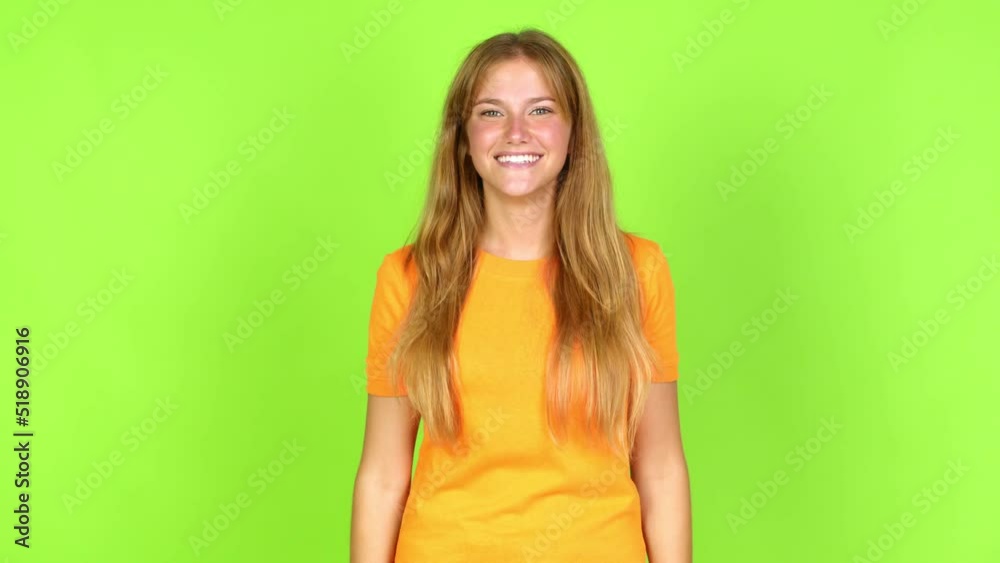Young pretty blonde woman on green screen chroma key covering eyes by hands. Surprised to see what is ahead over isolated background Young pretty blonde woman on green screen chroma key covering eyes by hands. Surprised to see what is ahead over isolated background