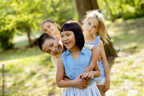 Group of asian and caucasian kids having fun in the park