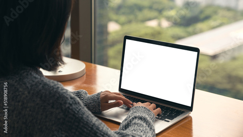 women using laptop showing white screen on desk photo
