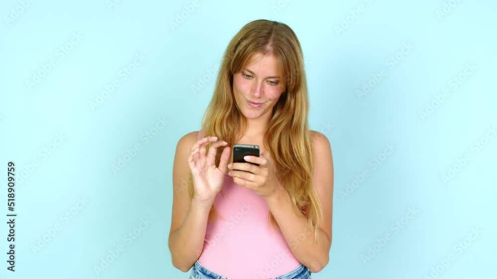 Young pretty blonde woman using mobile phone over isolated background Young pretty blonde woman using mobile phone over isolated background