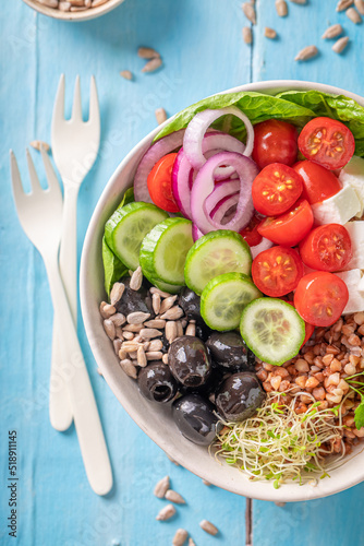 Colorful Greek salad with vegetables, cheese and buckwheat groats.