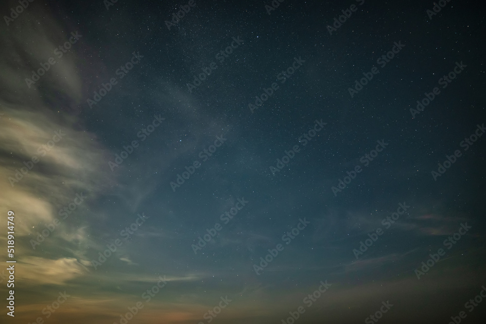 Beautiful noctilucent cloud formations against Milky Way background night sky