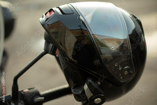 Motorcyclist helmet. Black helmet on motorcycle. Security tool.
