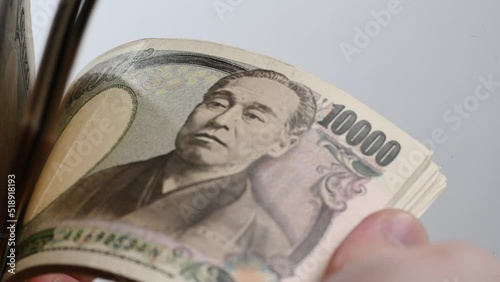 Closeup of Japanese accounting 1,000 yen banknotes money saving cash for the economy.
