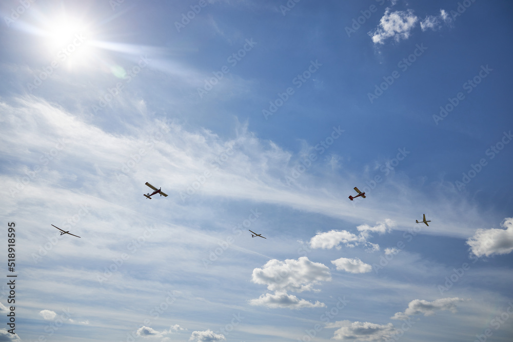 Five sports planes against the blue sky and the sun. Five sports planes against the blue sky and the sun.