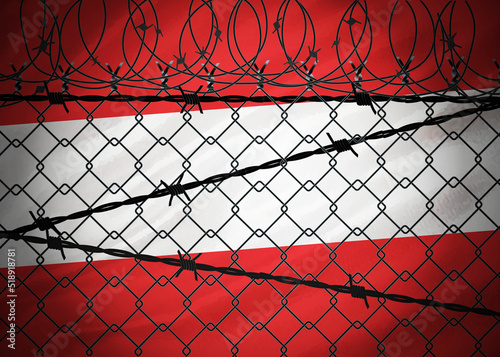 Austria flag behind barbed wire and metal fence