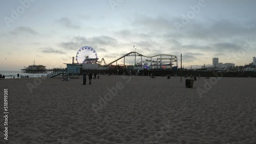 Los Angeles, California, USA, June 21, 2022: View of Santa Monica Beach and the Pier at sunset. Santa Monica Ferris Wheel and Roller-coaster.