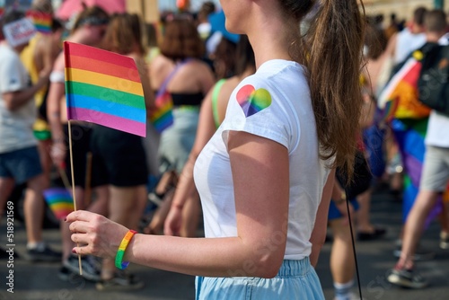Photography Image of woman holding rainbow flag at LGBT pride parade