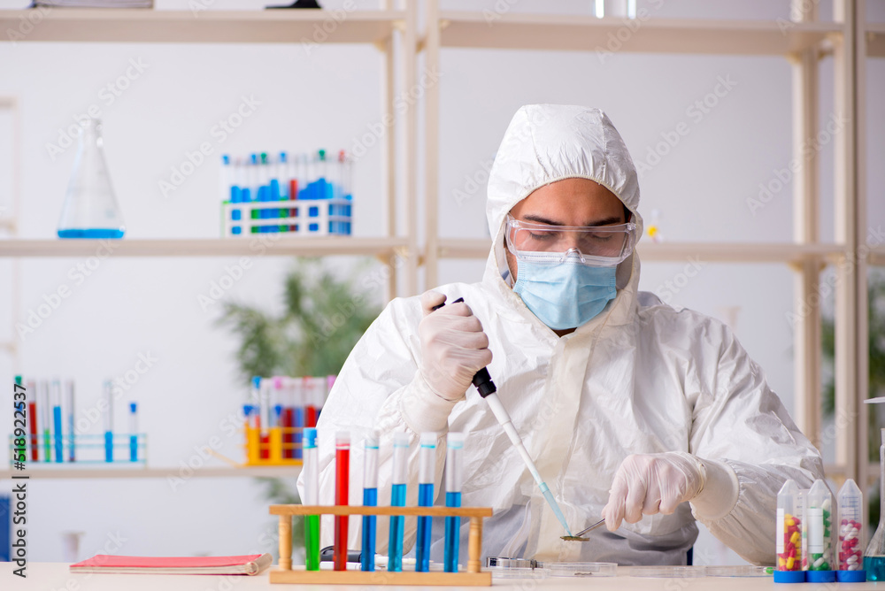 Young male chemist working at the lab during pandemic Young male chemist working at the lab during pandemic