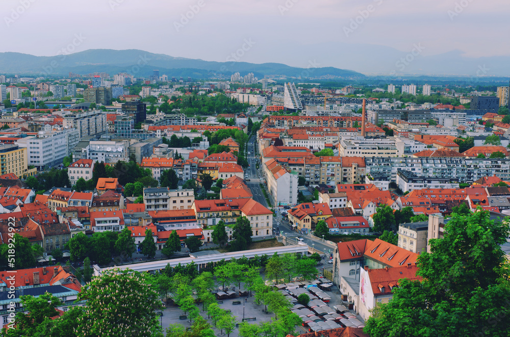 Aerial panoramic view of Ljubljana, capital of Slovenia in warm sunset light. Travel destination. Red roofs.