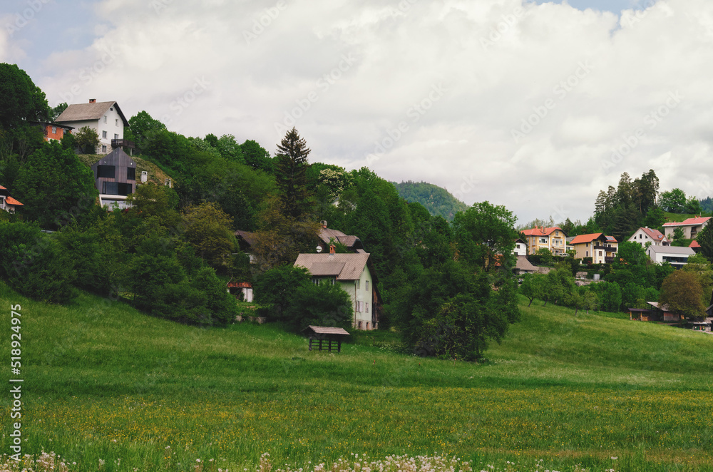 village on the green hills in the Alps mountains. Europe. Slovenia. Rural landscape.