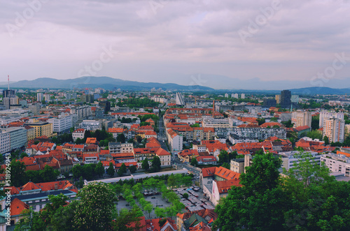 Aerial panoramic view of Ljubljana, capital of Slovenia in warm sunset light. Travel destination. Red roofs.