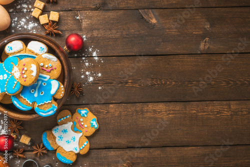 Ingredients for cooking Christmas cookie man on wooden background with decorations top view