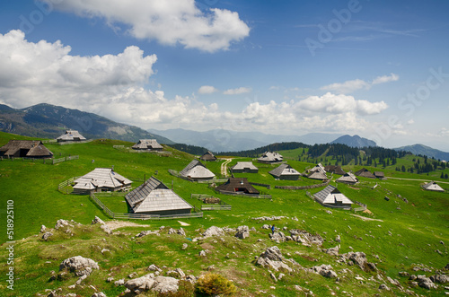 Velika Planina or Big Pasture Plateau in the Kamnik Alps, Slovenia. Mountain cottage hut or house on green hill. Alpine meadow landscape. Eco farming