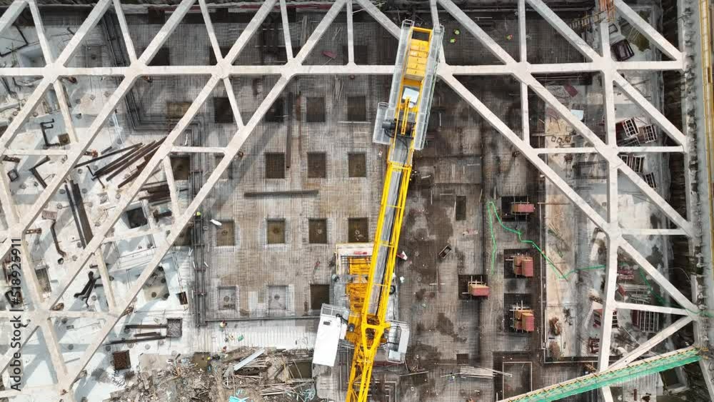 Construction site, cranes and workers. Drone aerial view. Buildings in construction in downtown, foundation in development Shanghai China. Economy industry, house development concept b-roll footage. Construction site, cranes and workers. Drone aerial view. Buildings in construction in downtown, foundation in development Shanghai China. Economy industry, house development concept b-roll footage.