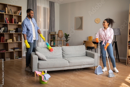 African Couple Cleaning Room Doing House Chores Together At Home