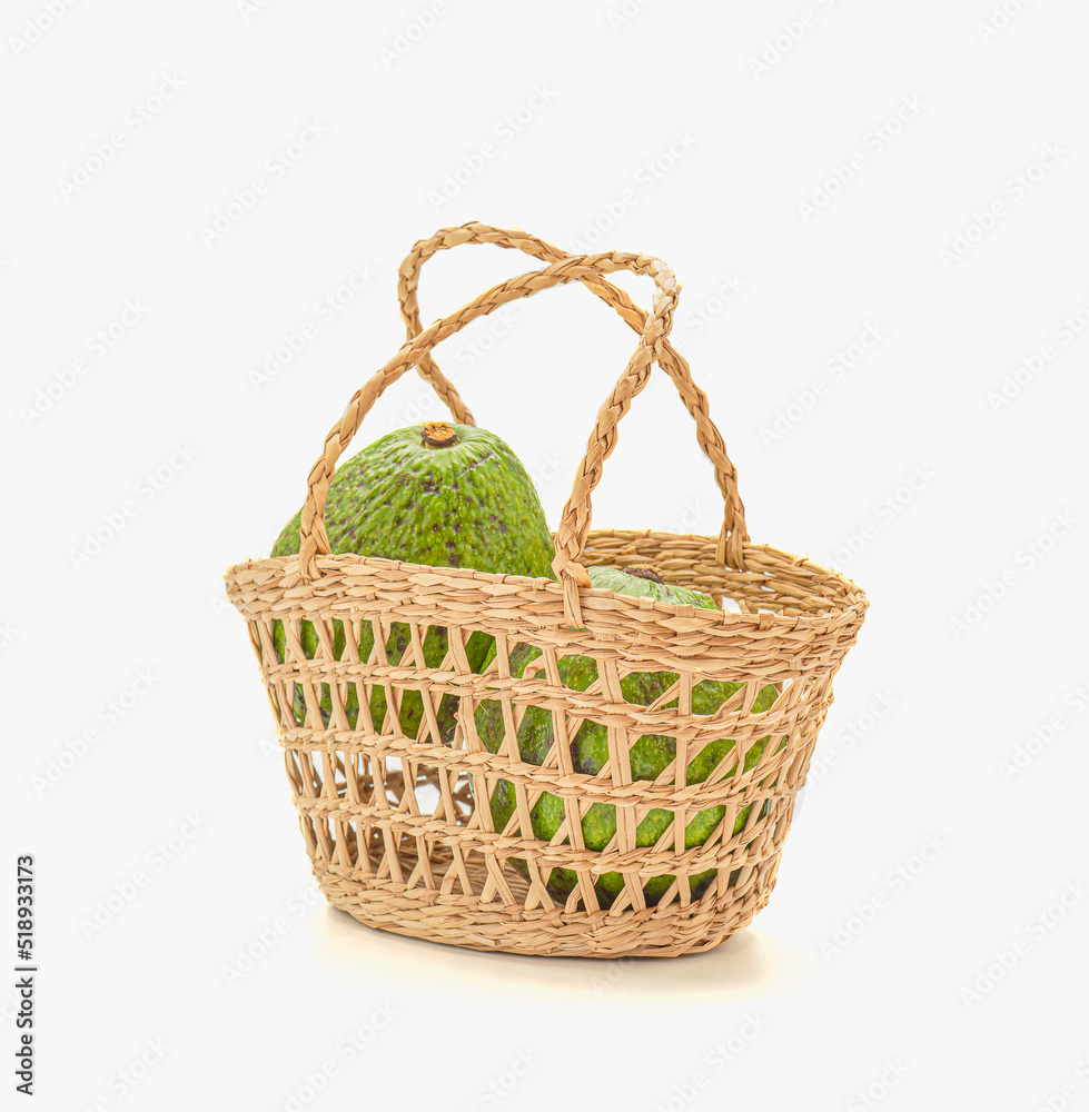 A basket of avocados on a white background A basket of avocados on a white background