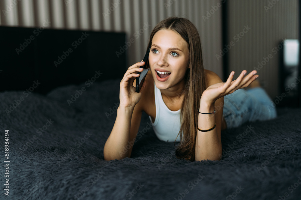 Beautiful young woman using mobile phone in the bed Beautiful young woman using mobile phone in the bed