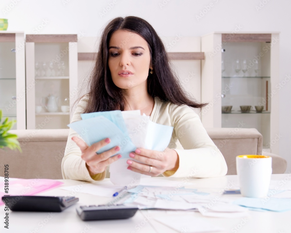Young woman with receipts in budget planning concept Young woman with receipts in budget planning concept