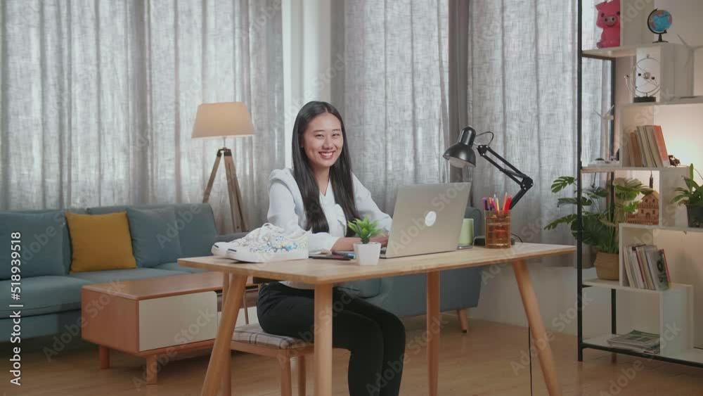 Asian Female Footwear Designer Smiling To The Camera While Working On A Laptop At Home
Asian Female Footwear Designer Smiling To The Camera While Working On A Laptop At Home