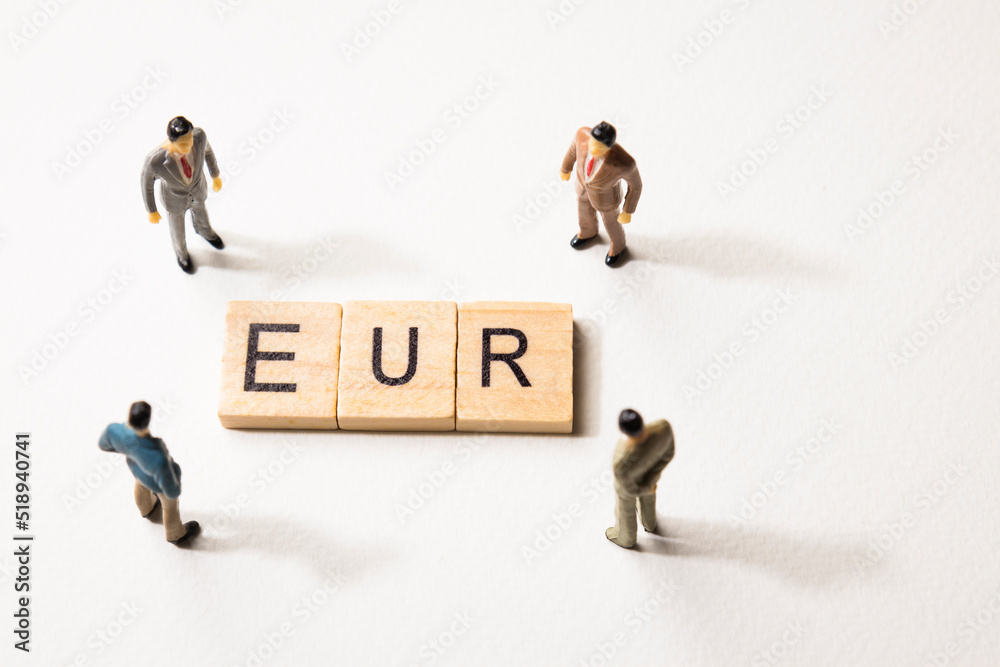 businessman figures at EUR words