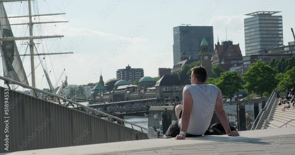 Man rest after exercise in the Hamburg port, hot sunny day Man rest after exercise in the Hamburg port, hot sunny day