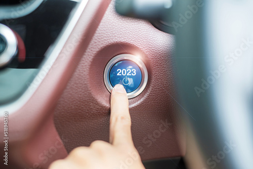 Obraz na płótnie Finger press a car ignition button with 2023 START text inside  automobile