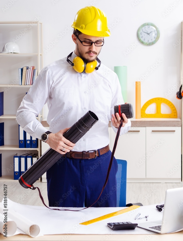 Young male architect working in the office Young male architect working in the office